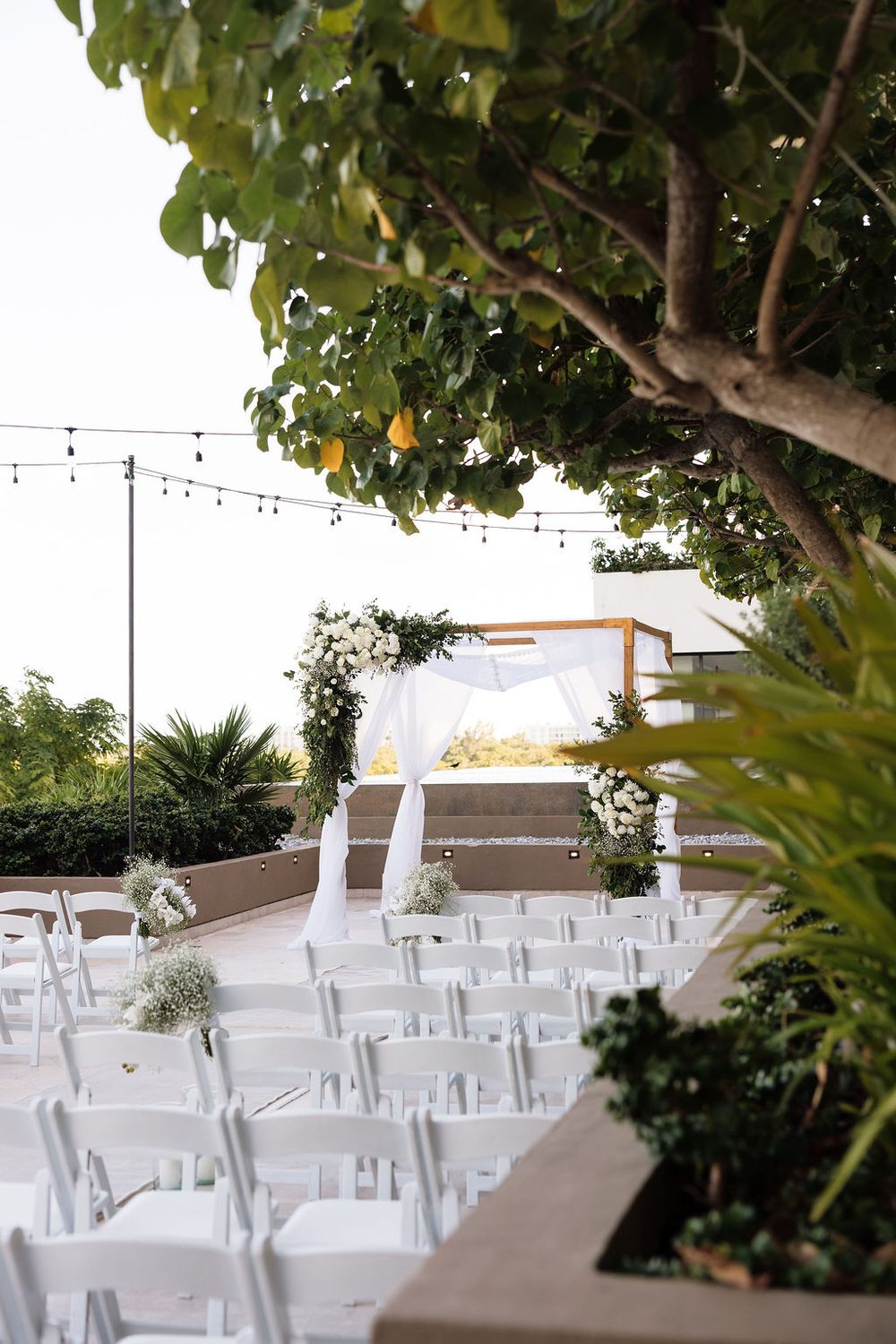 Wedding ceremony arch with greenery